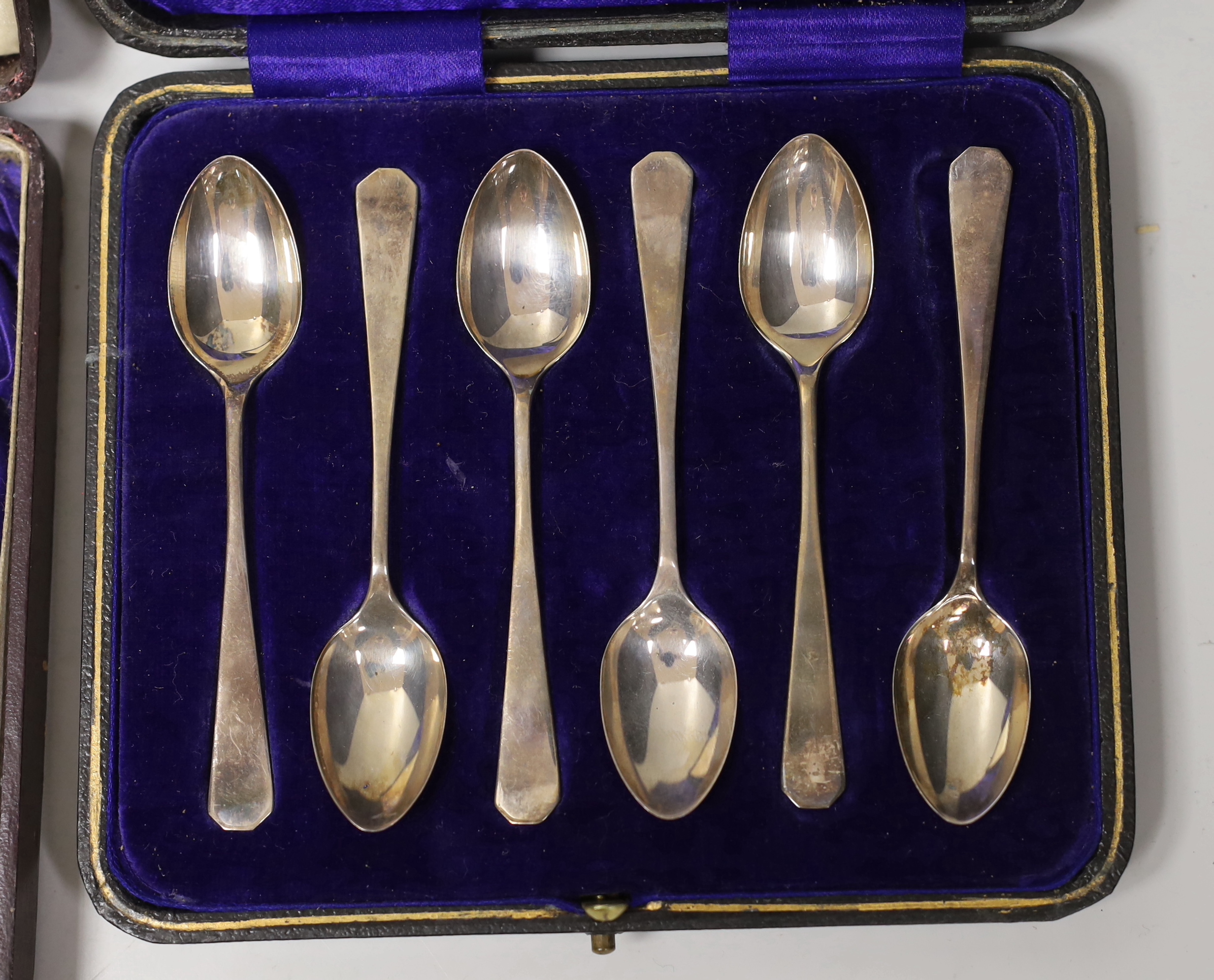 Three assorted cased sets of six silver tea or coffee spoons, one with tongs and other incomplete set.